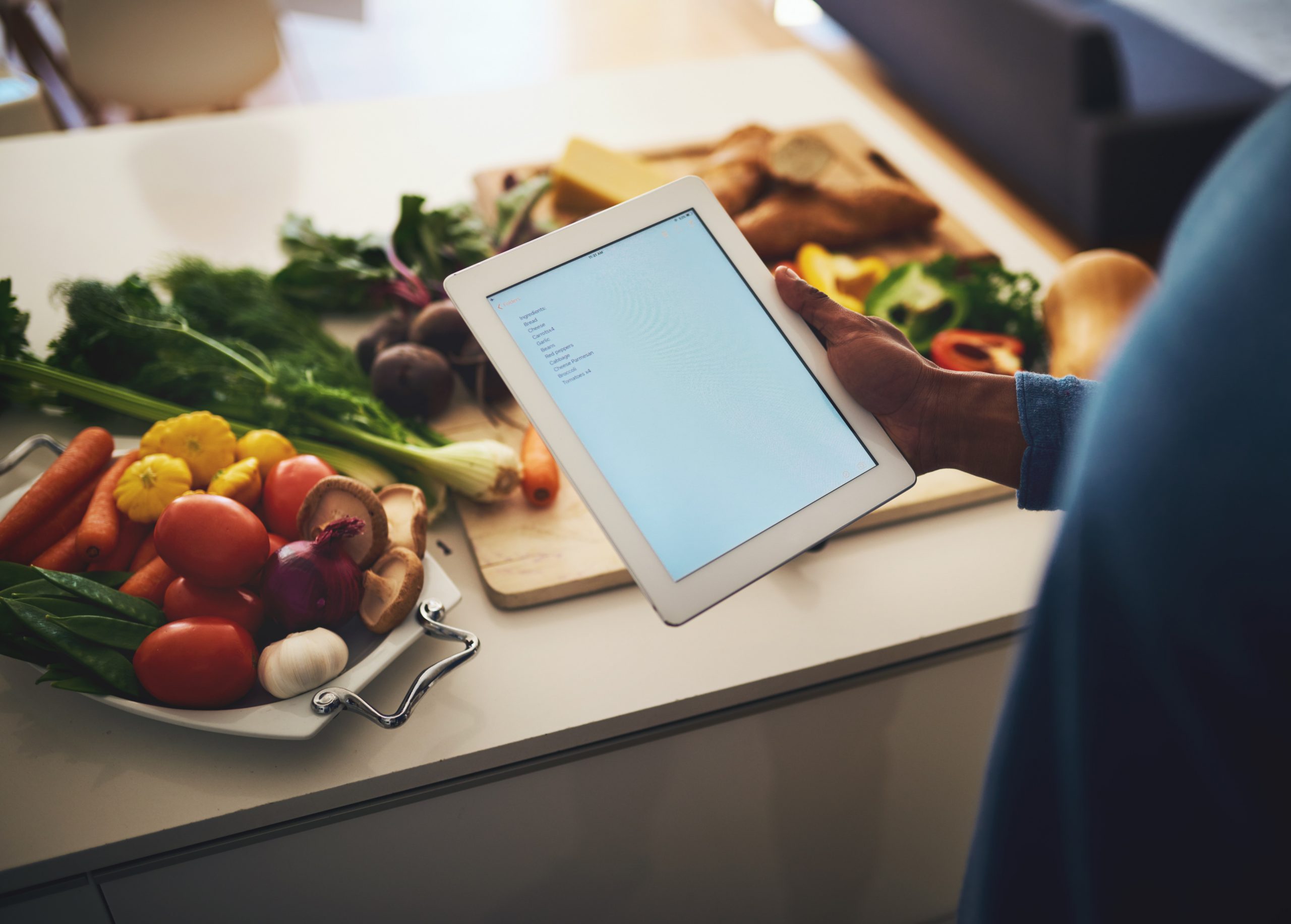 hand-kitchen-counter-screen-tablet-with-vegetables-recipe-cooking-with-diet-nutrition-fresh-food-person-home-mock-up-with-research-organic-ingredients-with-vegetarian-meal