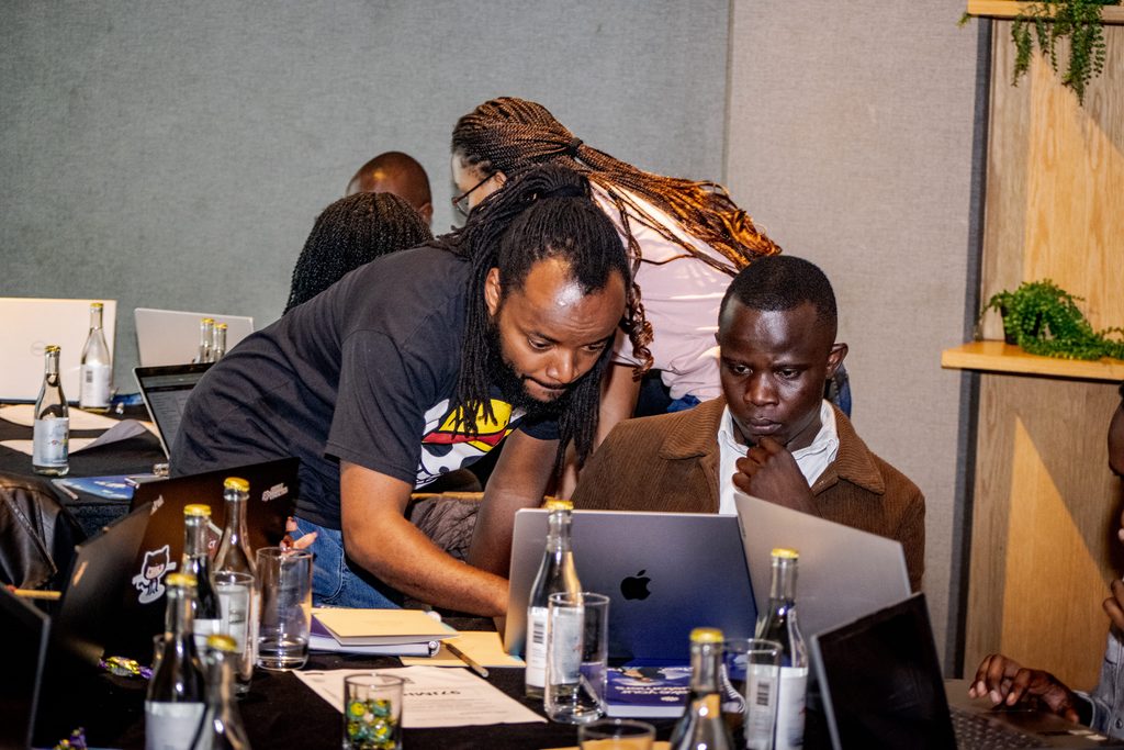 John Higi, Senior Data Engineer at Pawa IT, working through a BigQuery ML K-means clustering exercise with an attendee at Cloud Mastery 2026 in Nairobi.