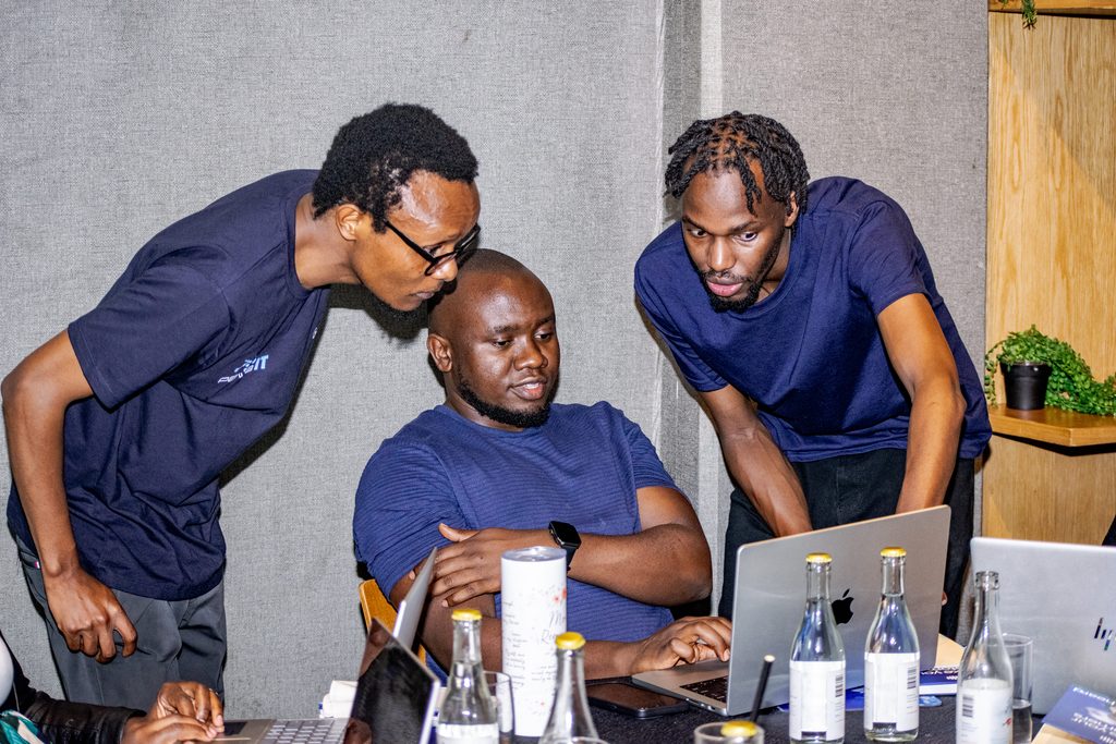 Eddie Ngugi, Head of Engineering and Evans Mwongera, Cloud Architect at Pawa IT, debugging a Cloud Run deployment side by side with an attendee at Cloud Mastery 2026 in Nairobi.
